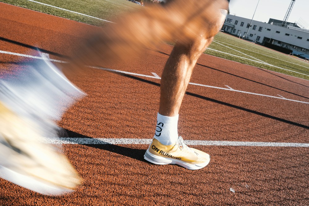 Runners moving along an outdoor athletics track